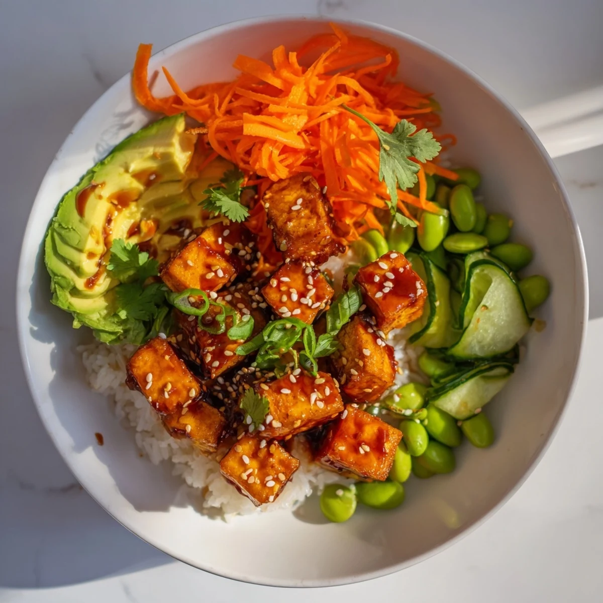 Crispy ginger sesame tofu bowl with vibrant vegetables, a flavorful vegan dish.