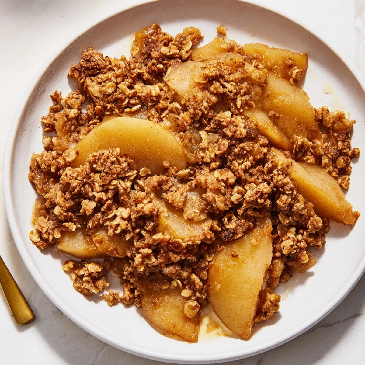 Warm, bubbly Spiced Pear Crisp with a golden oat topping, ideal for a cozy dessert.