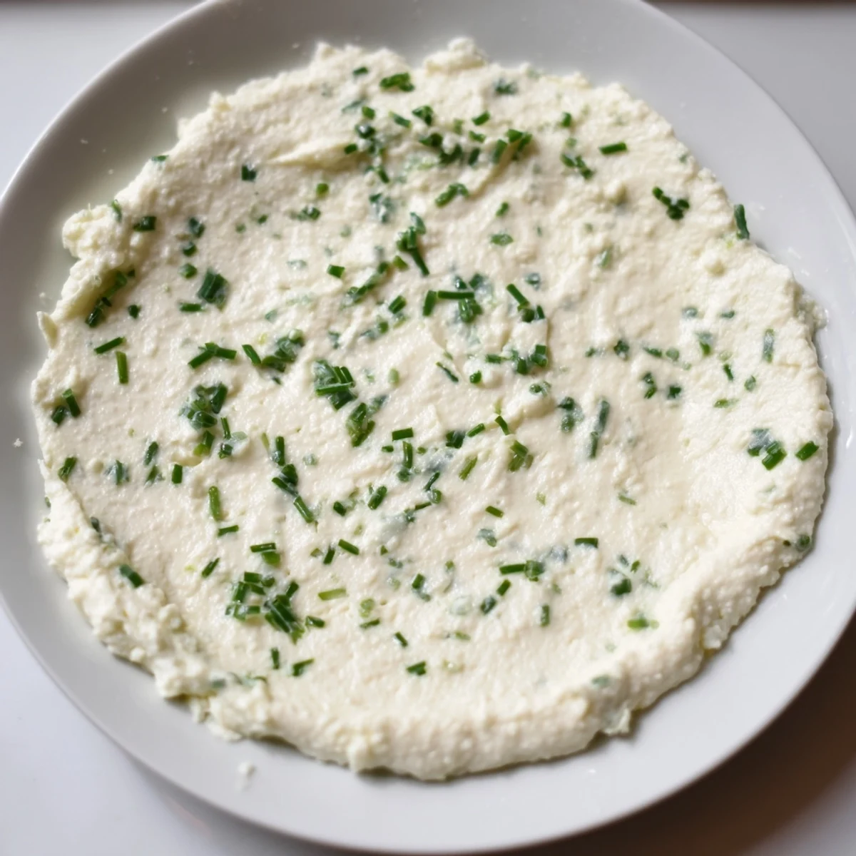 *   Creamy cheese spread, whipped smooth, ready to be scooped up with crackers for a delicious appetizer.