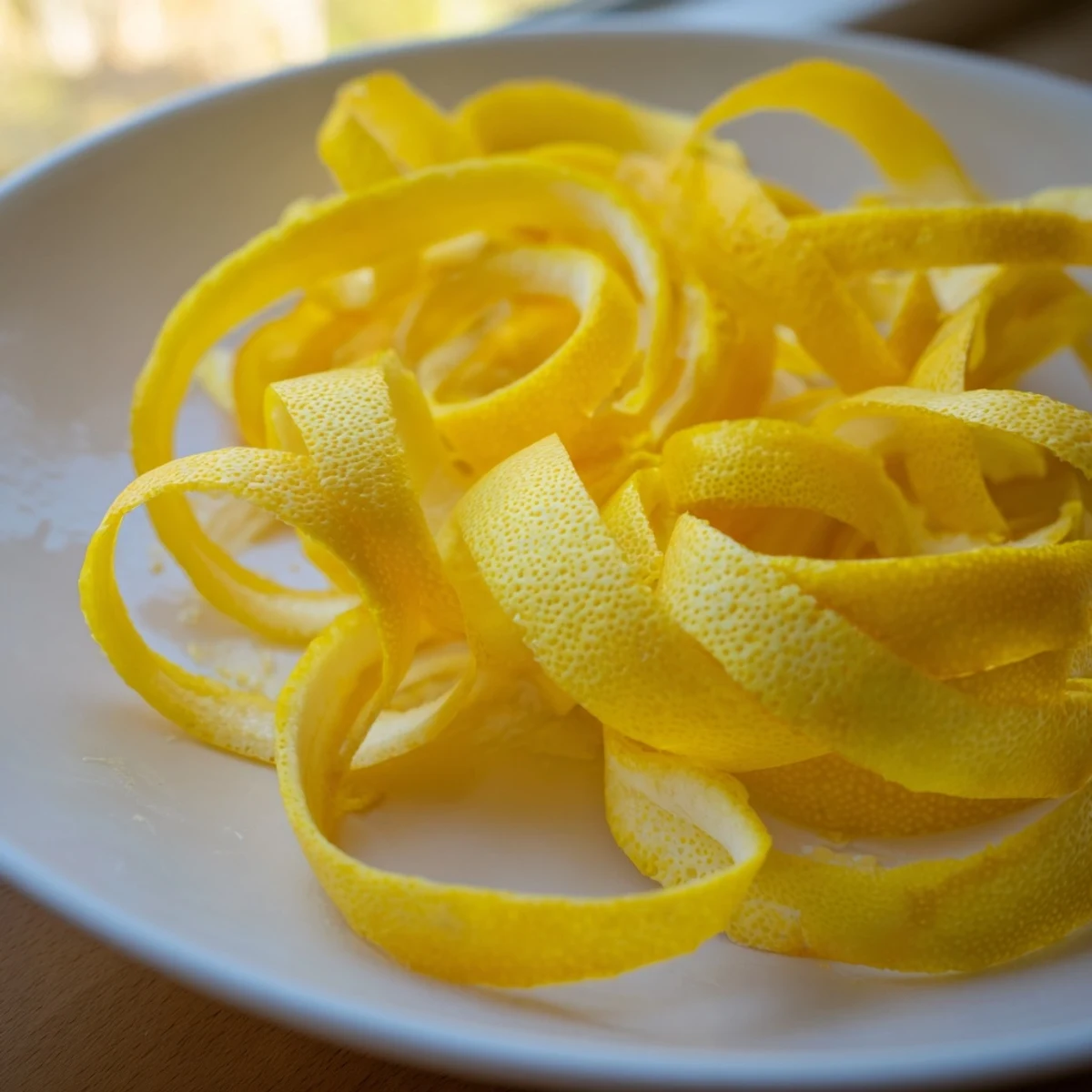 Thin, bright lemon garnish slices ready to brighten a cocktail with a zesty aroma and color.