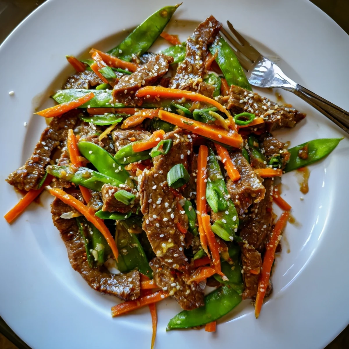 Aromatic beef stir fry with snow peas, showcasing the perfectly seared beef and colorful vegetables.