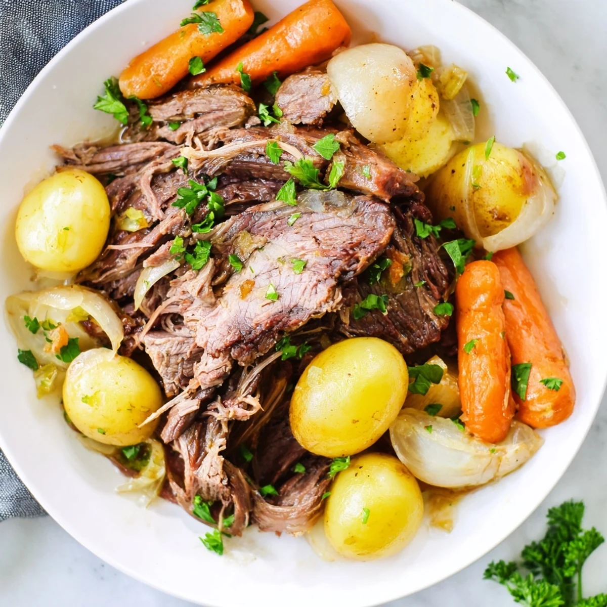 Tender slow cooker pot roast with carrots, vegetables, and savory gravy, ready to serve.