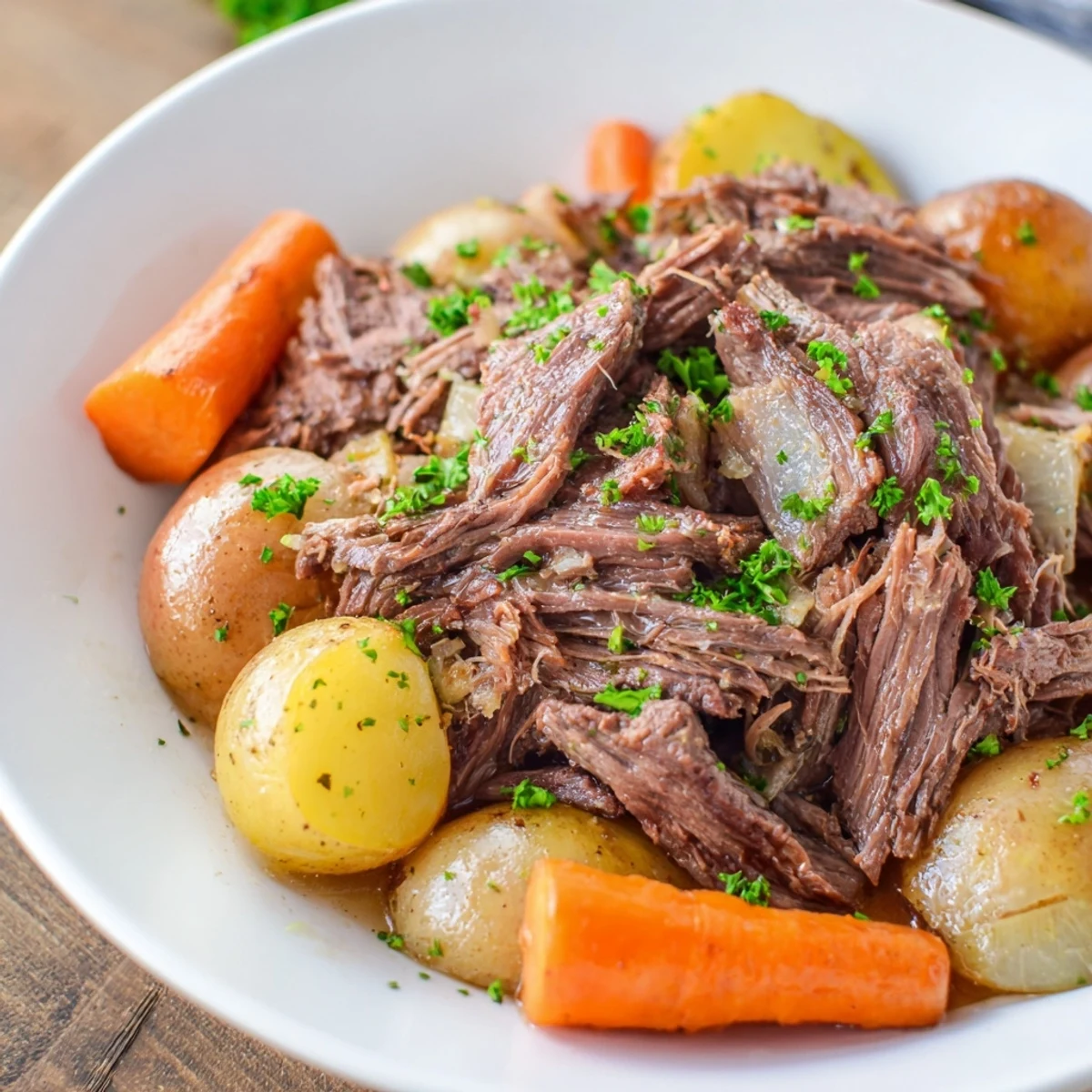 Golden, slow-cooked pot roast with carrots, a hearty, comforting family meal on a plate.