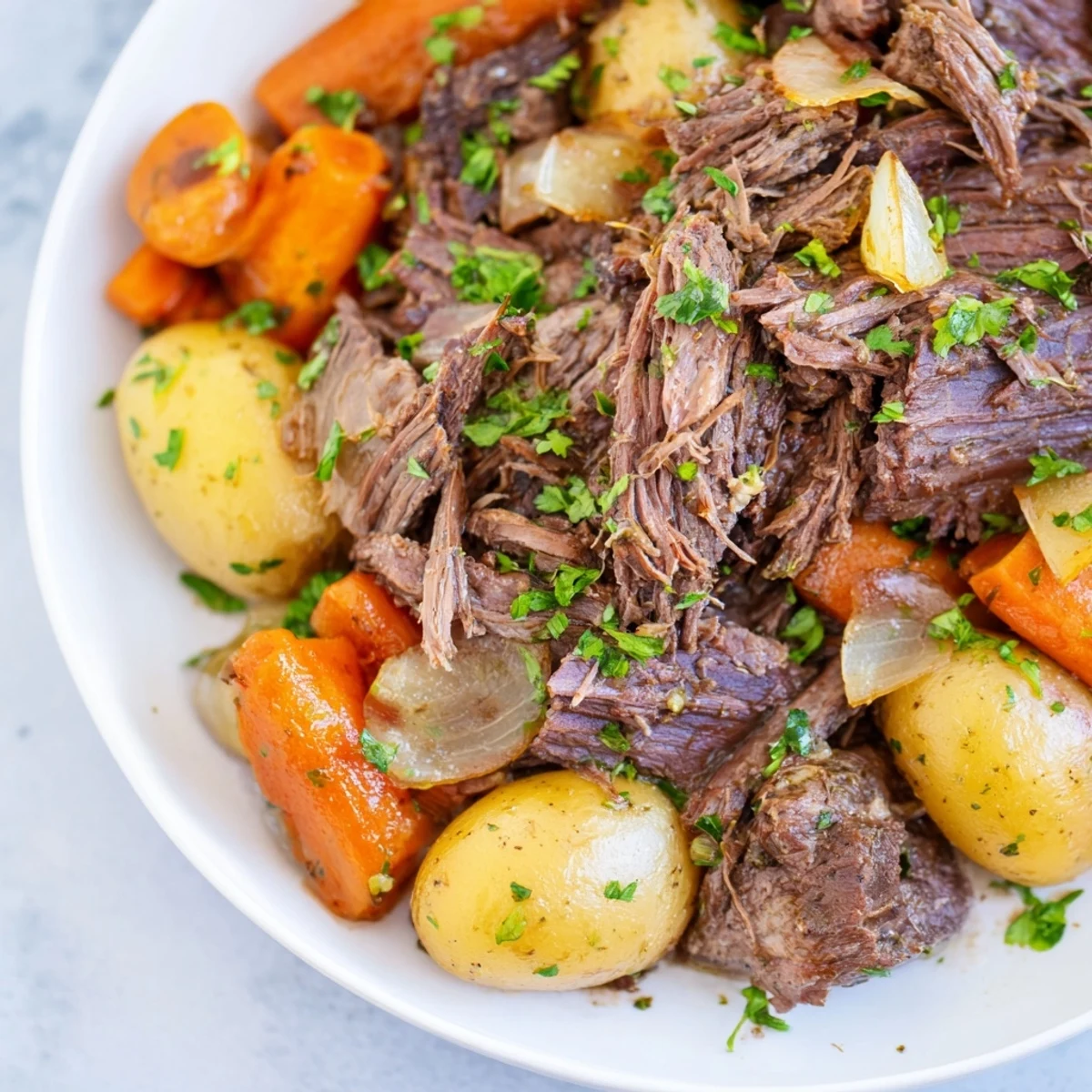A close-up of a steaming, fall-apart slow cooker pot roast with carrots, perfect dinner.