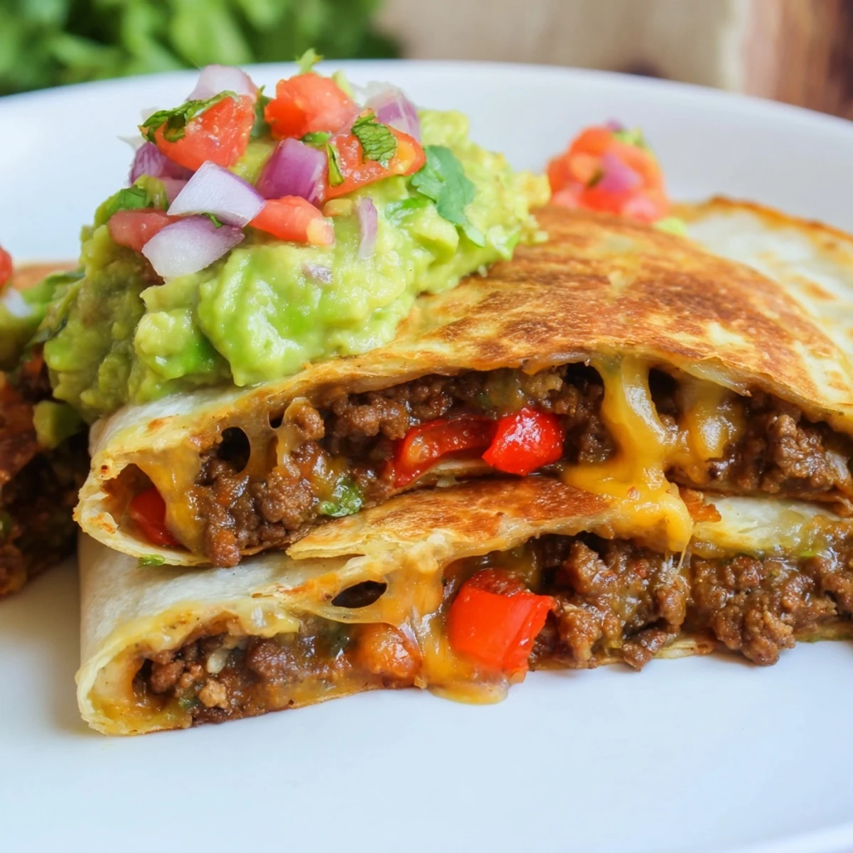 A close-up of crispy beef quesadillas, with creamy guacamole and fresh salsa on the side