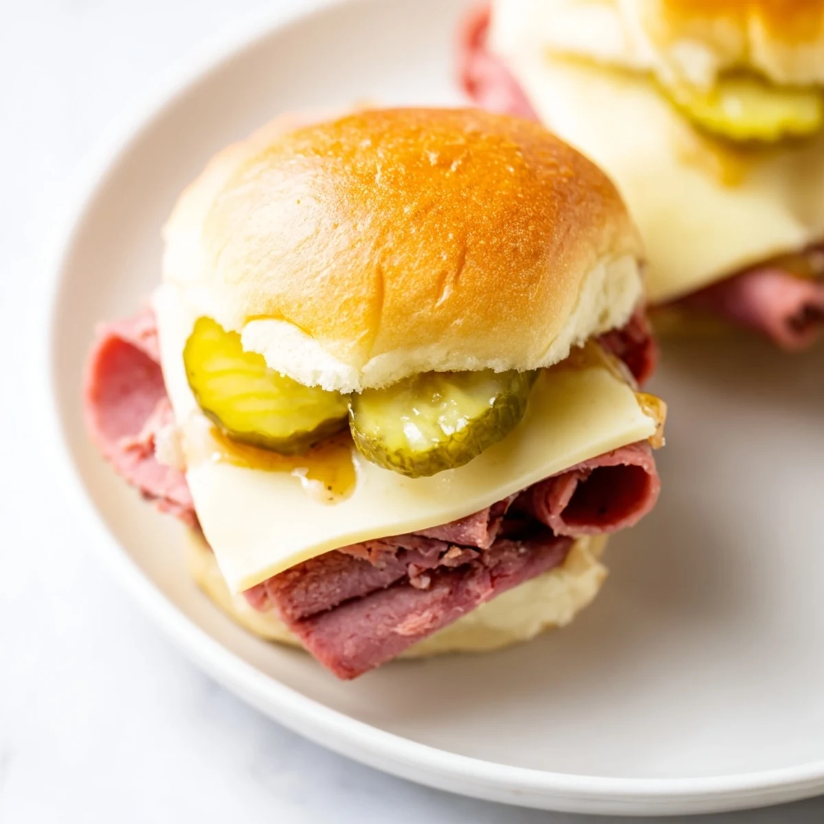 Servings of Corned Beef Sliders with Mustard garnished with fresh parsley on a wooden board.