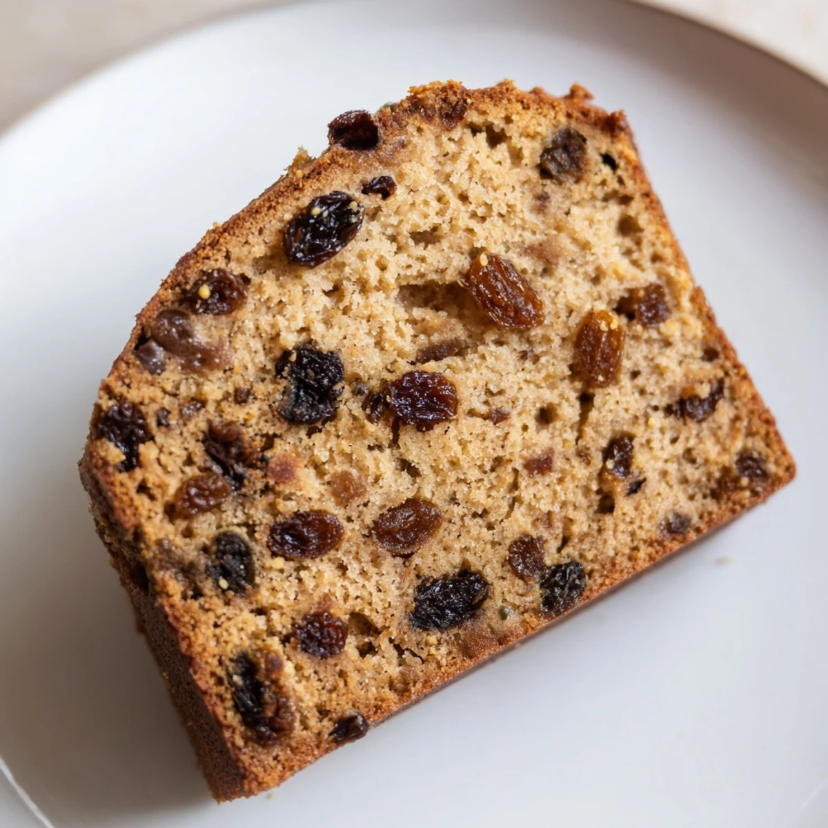 Golden baked Irish Tea Cake with Dried Fruit on a cooling rack, rich crumb with lemon zest.