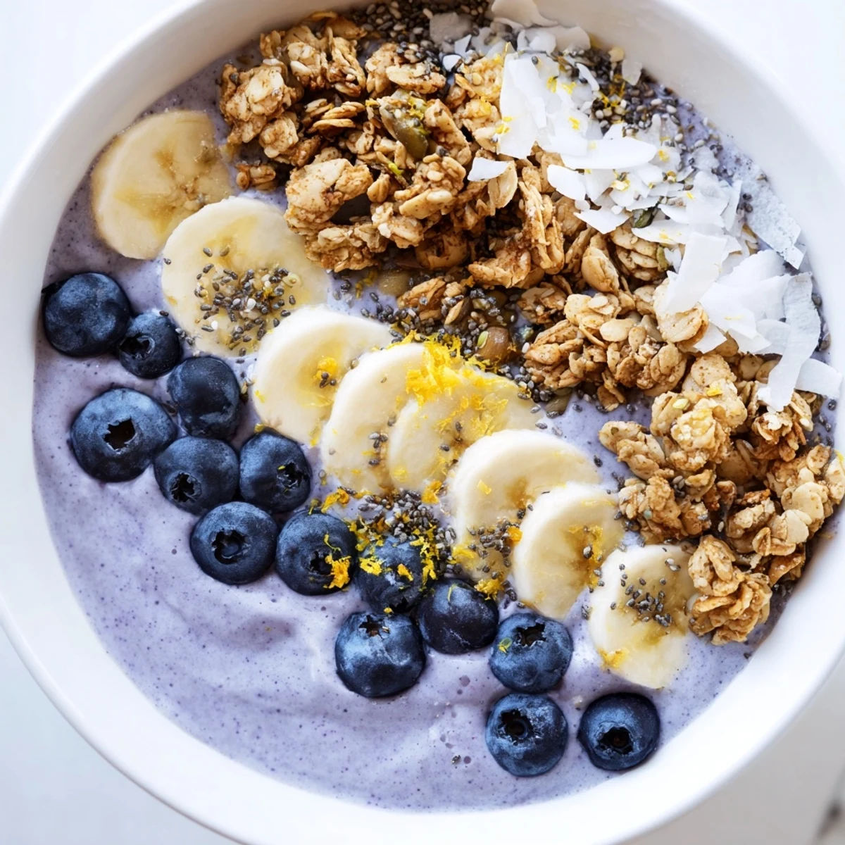 A vibrant Lemon Blueberry Smoothie Bowl with Granola, a refreshing American breakfast recipe with zesty lemon and frozen blueberries.